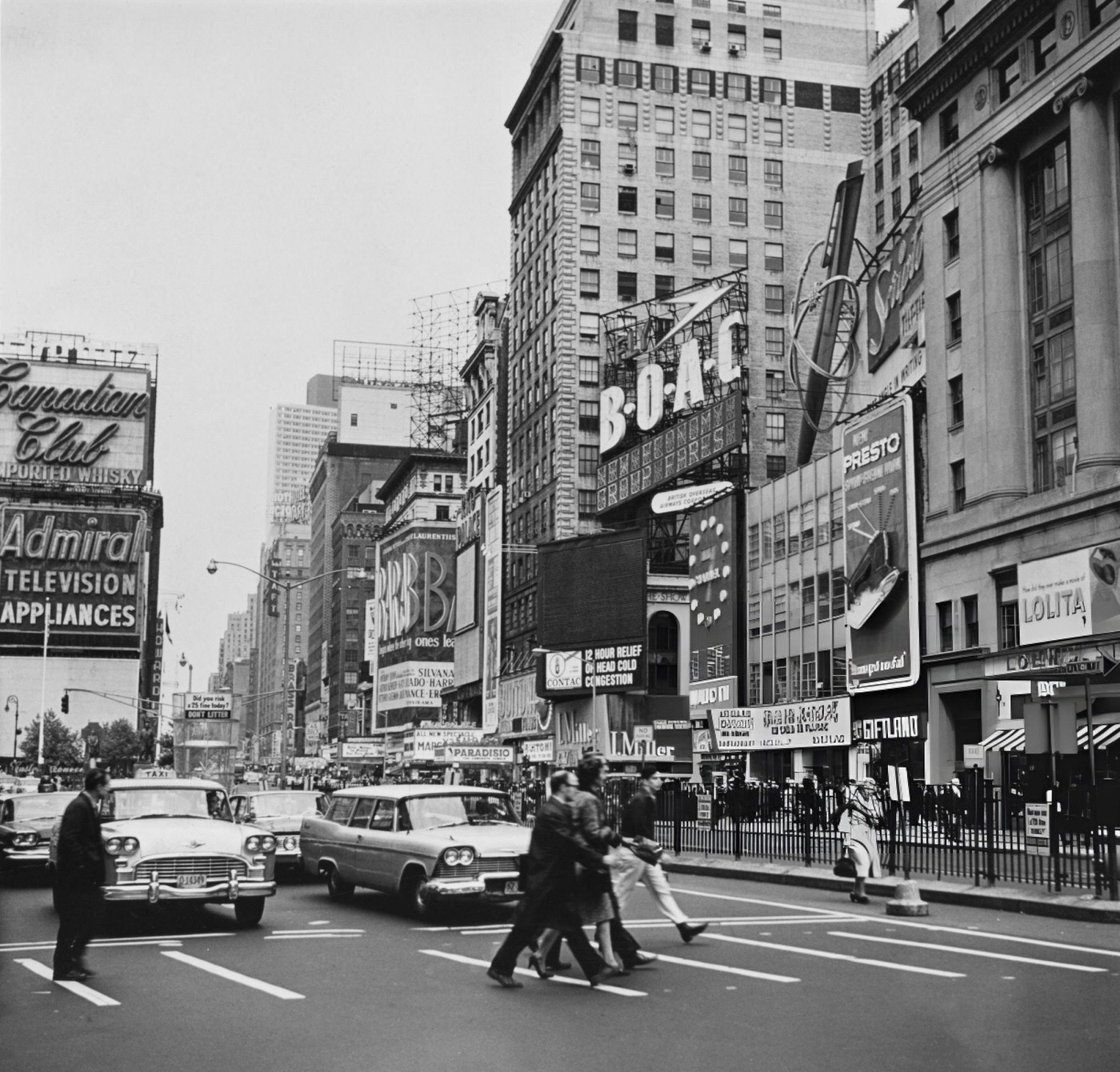 Pedestrians And Traffic On Times Square, With Commercial Signs And Advertisements On The Buildings, 1962.