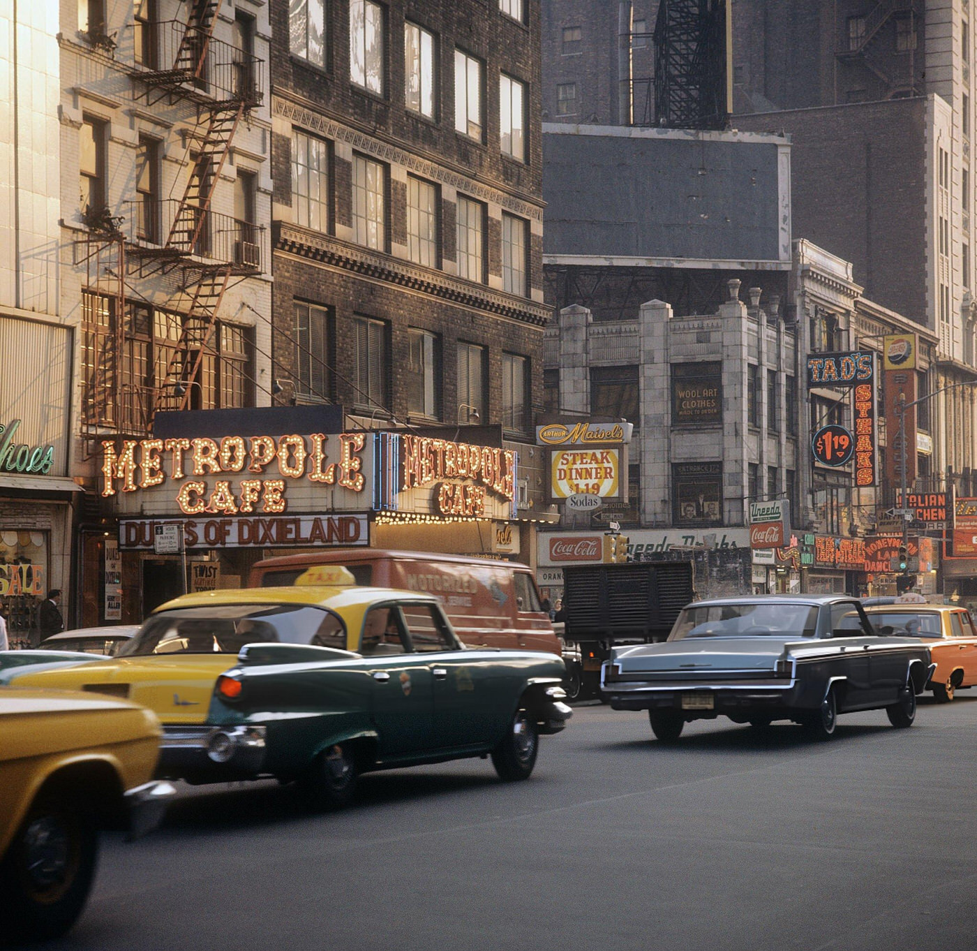 A Street Scene With Cars And Taxis Driving On Broadway In Times Square, With The Metropole Cafe In Focus, 1964.