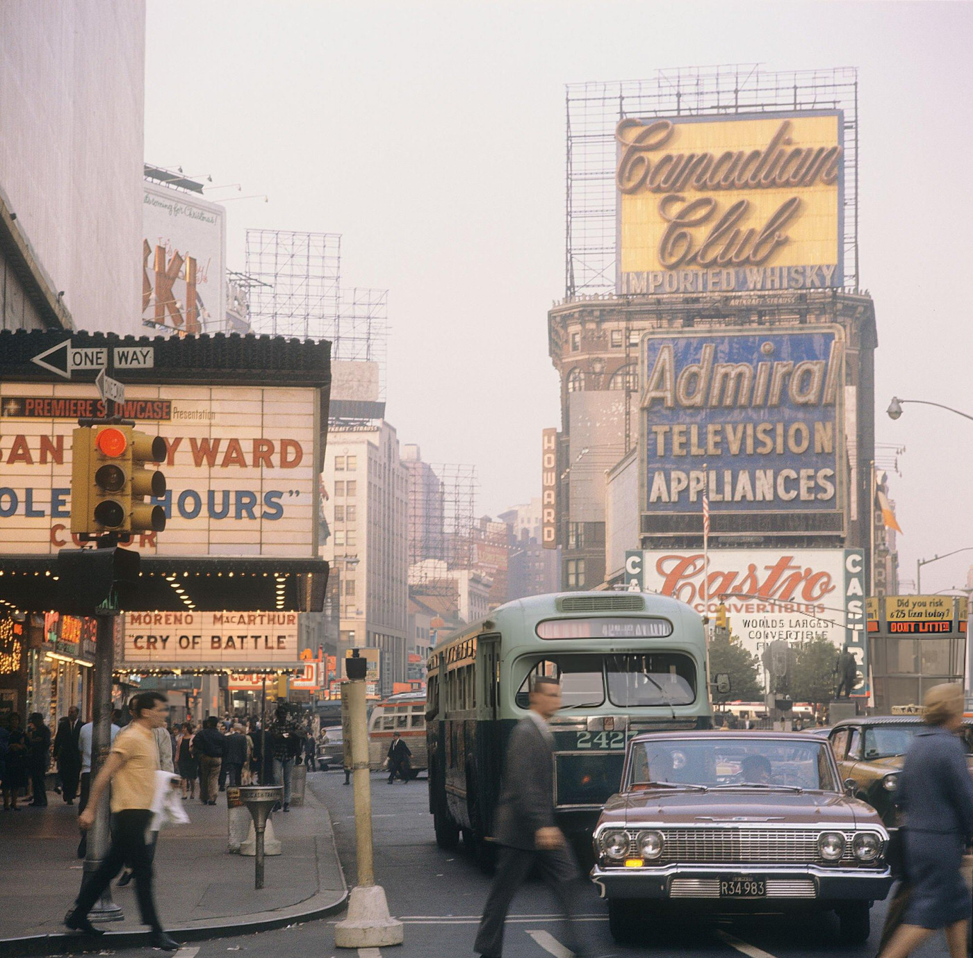 A Street Scene With Cars, Buses And Taxis Driving On Broadway In Times Square, Showing Movie Theatres, 1964.