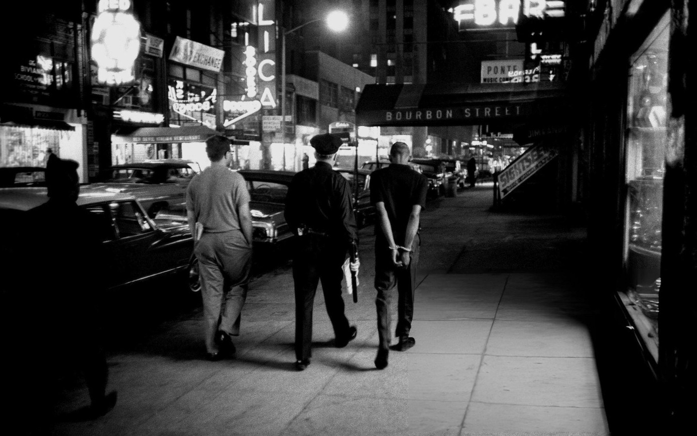 A Criminal Suspect In Handcuffs Is Escorted To The Police Station Near Times Square, 1965.