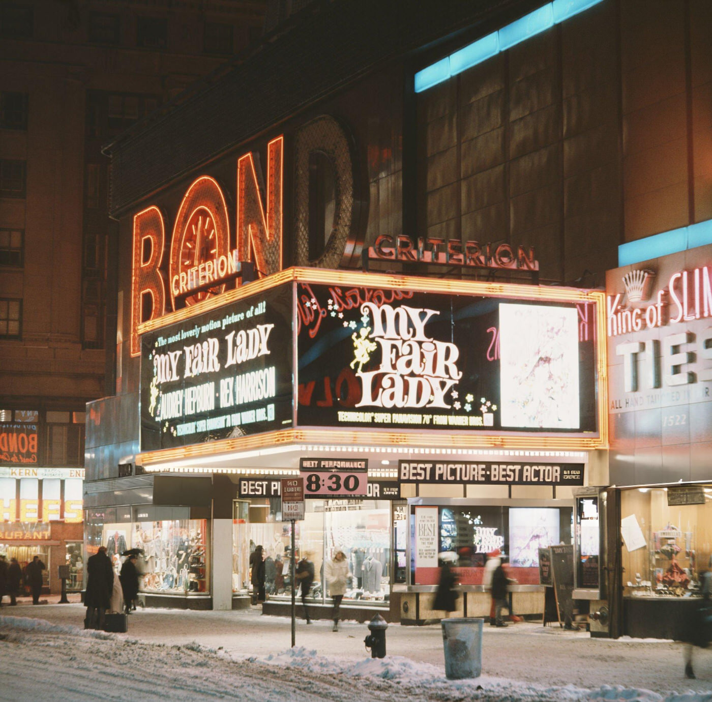 The Criterion Theater On Times Square, With Bond Clothes Behind, Circa 1965. The Movie Showing Is 'My Fair Lady'.