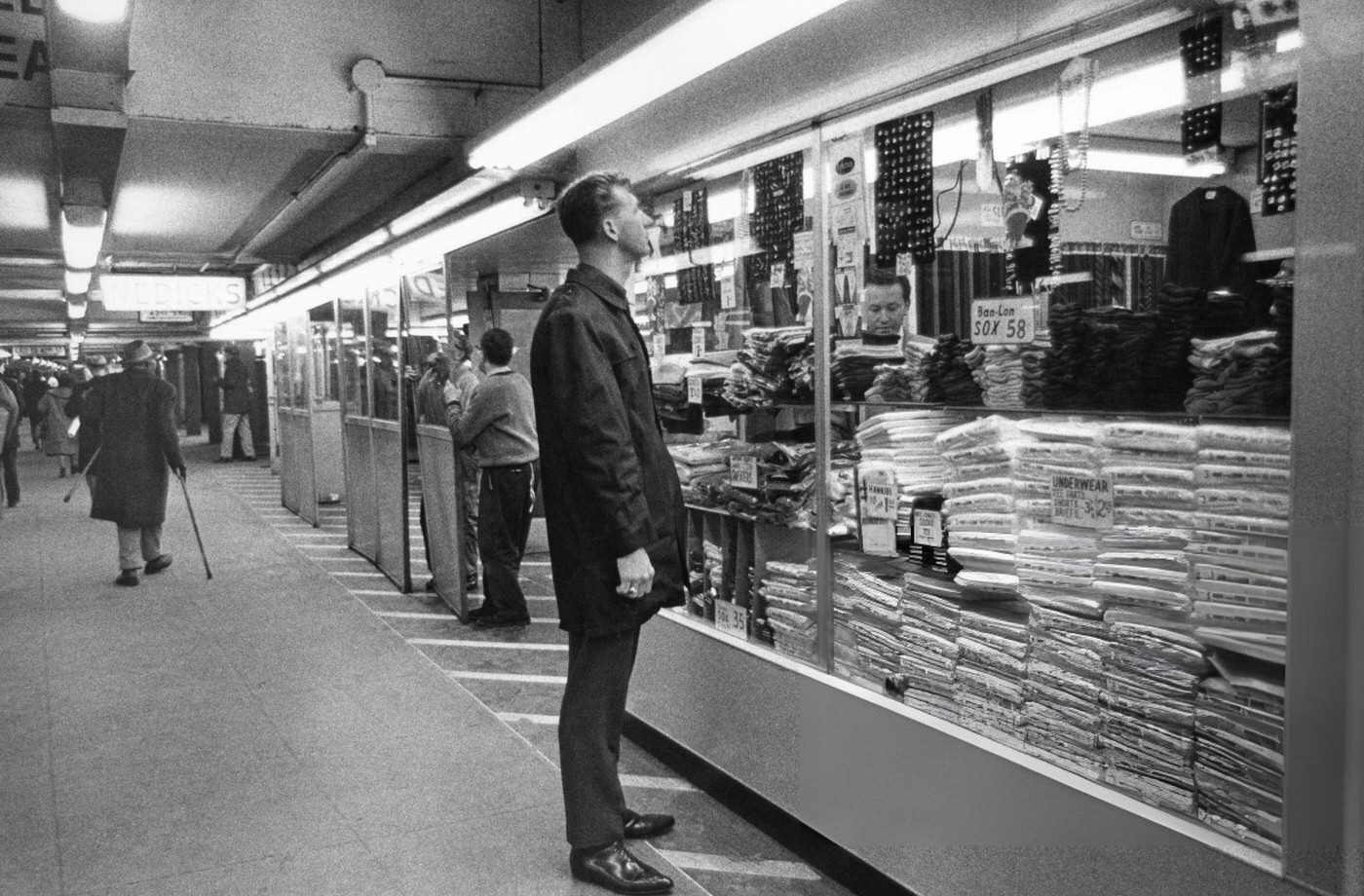A Street Scene In Times Square, Showing People Crossing The Street.