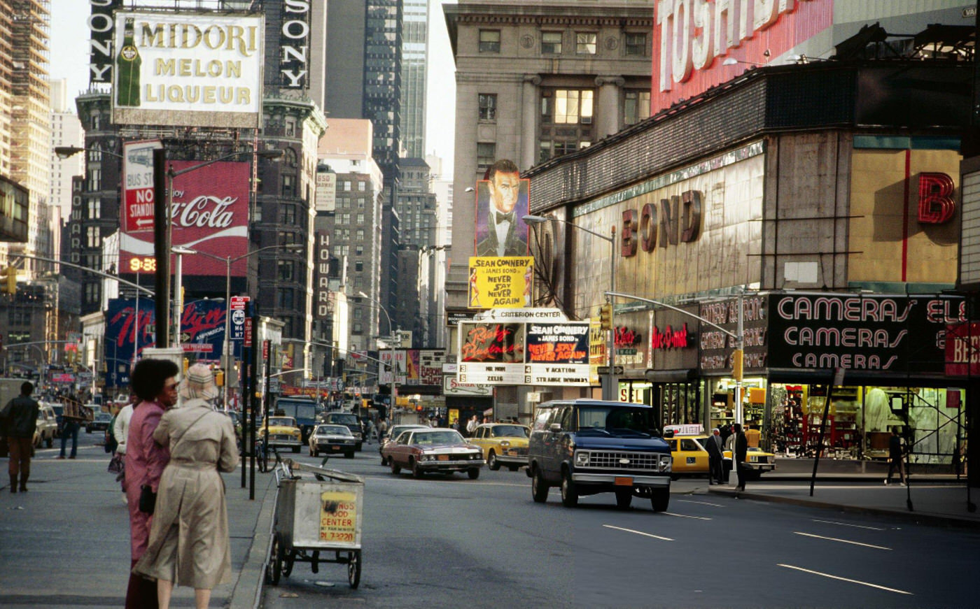 A Street Scene In Times Square, Showing The Coca-Cola And Midori Melon Liquor Signs.