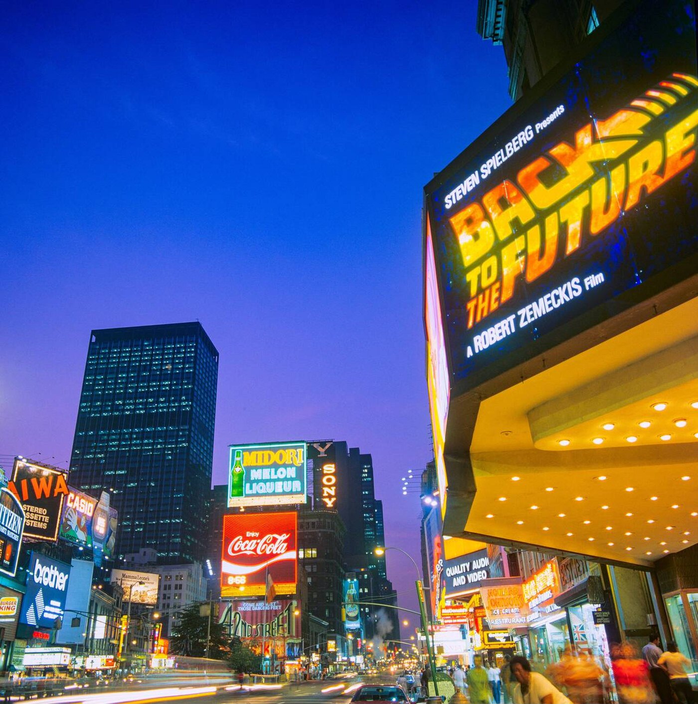 Times Square At Dusk, Illuminated Advertising Signs, Movie Theatre Marquee, Back To The Future Movie Advert, People, Midtown Manhattan, July 1985.