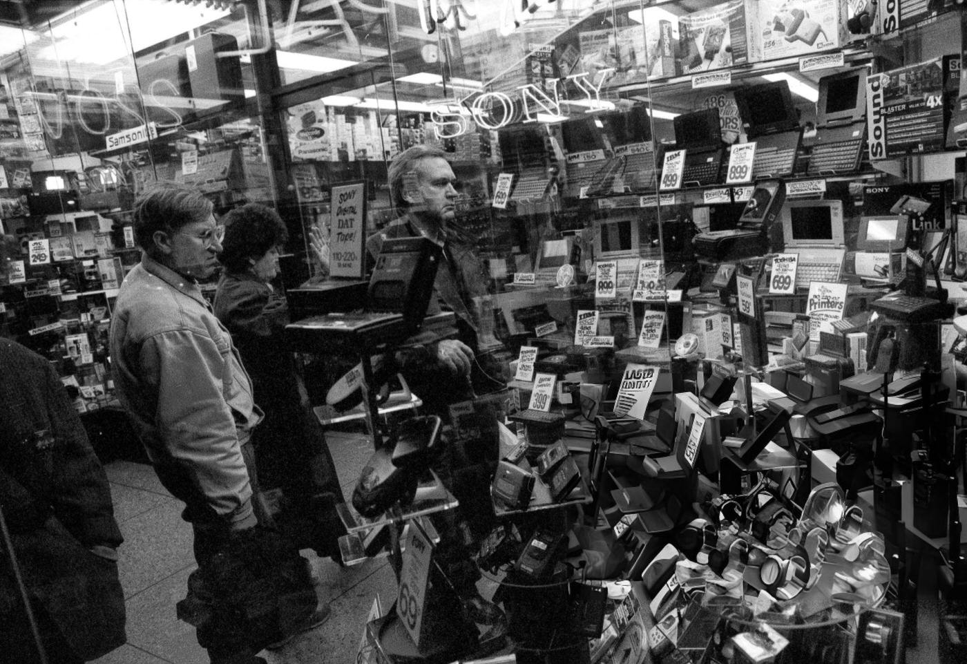 Shoppers Looking At Electronic Equipment In A Storefront Window On 42Nd Street, December 15, 1995.