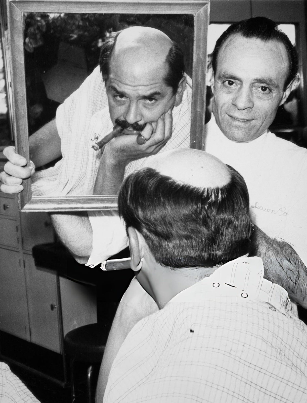 Barber Angelo Resciniti Showing Comedian Ernie Kovacs His Bald Pate For A Film Role At The Dawn Patrol Barber Shop, New York, 1958.