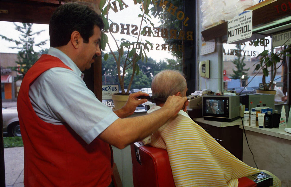 Barber And Customer Watching The Iran-Contra Hearings On Television, New York, 1987.