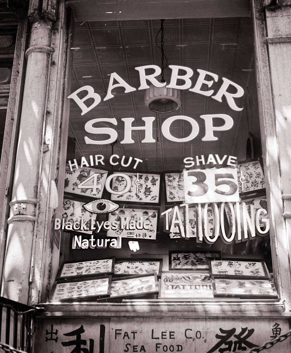 Barber Shop Window Advertising Tattooing, Black Eye Treatment, And Shaves In Chinatown, New York, 1940S.