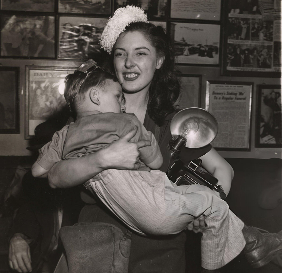 Woman With A Camera Carrying A Boy At Sammy'S On The Bowery On New Year'S Eve, New York, 1943.