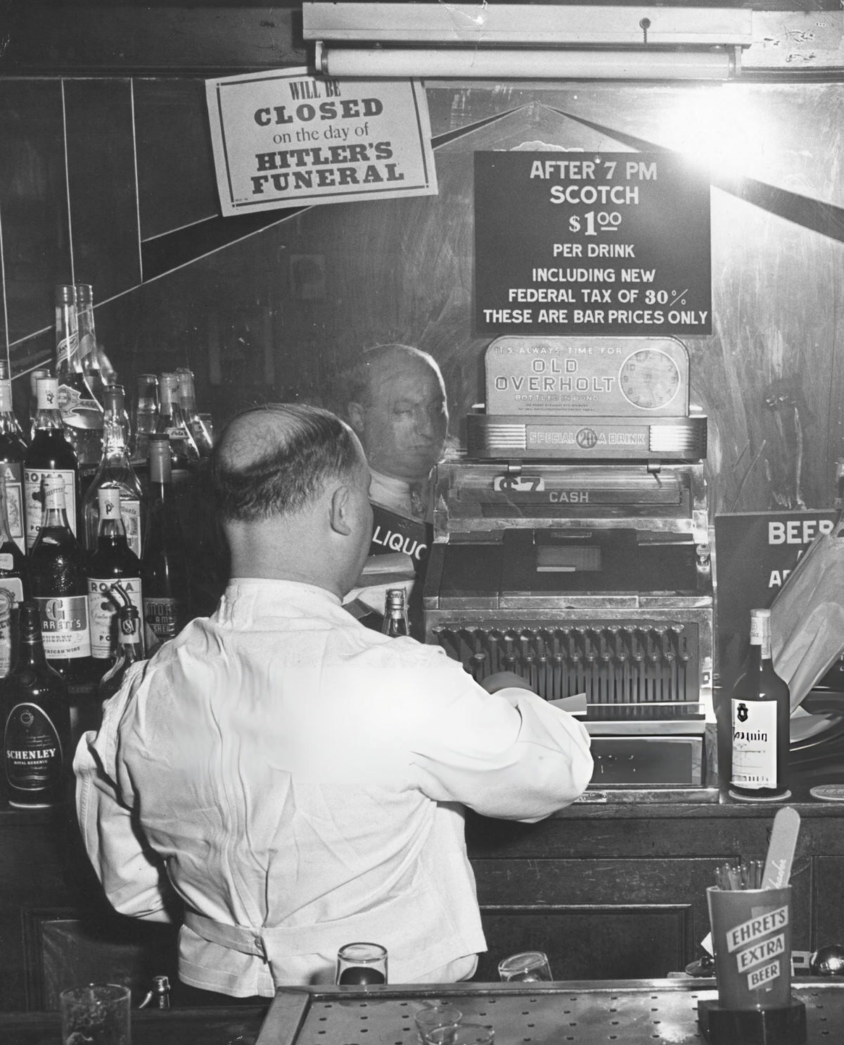Sammy Fuchs Behind The Bar At Sammy'S On The Bowery With A Sign Regarding Hitler'S Funeral, New York, 1944.