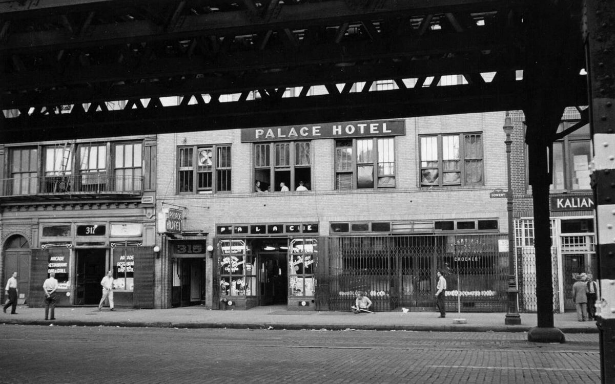 Street Scene Beneath An Elevated Train Track Featuring The Palace Hotel And Arcade Restaurant Bar And Grill, New York, 1940S.