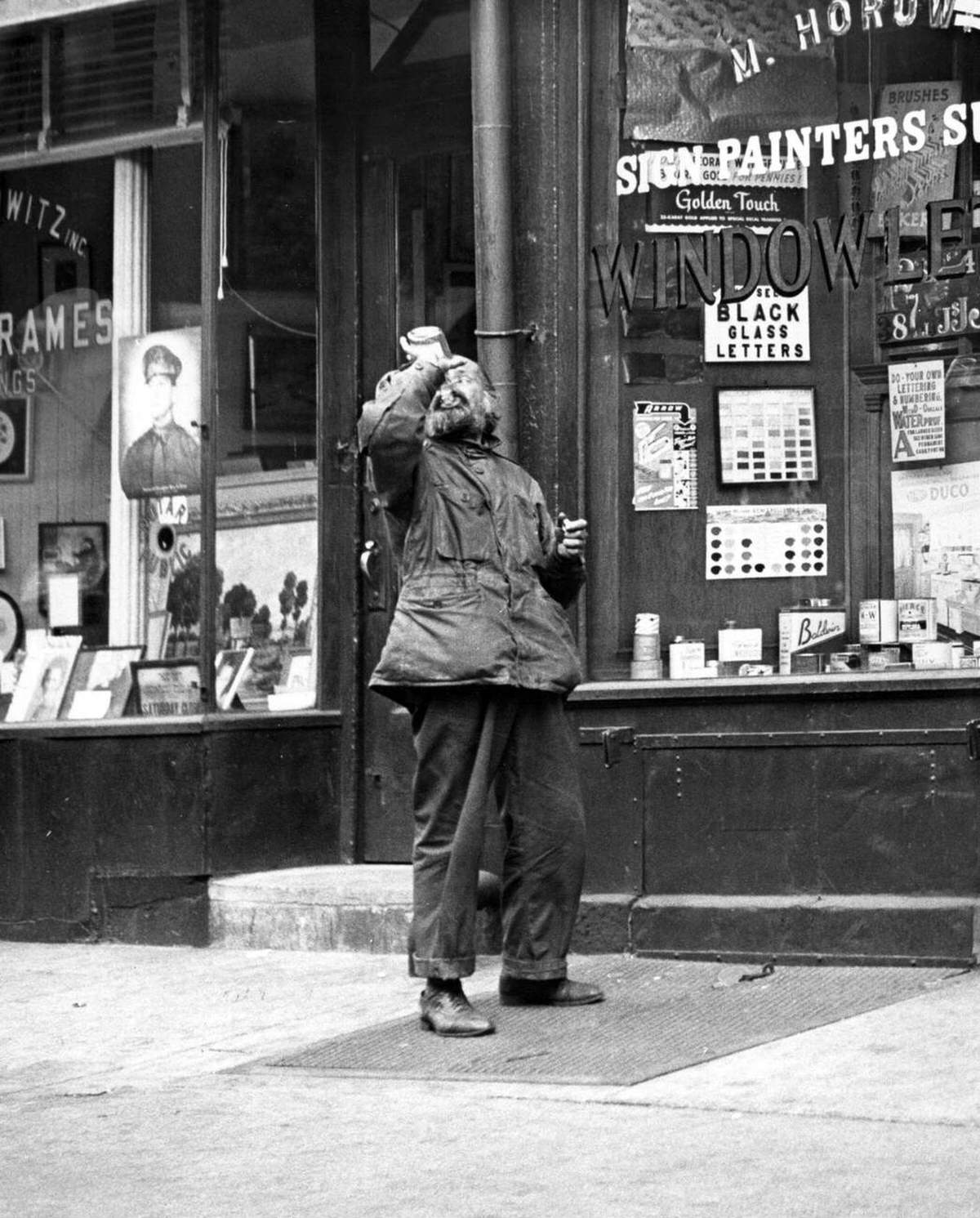 Bearded Man Standing In Front Of A Sign Painter'S Supply Shop On The Bowery, New York, 1948.