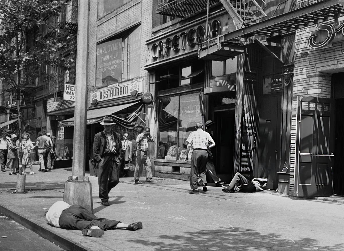 Pedestrians Passing People Sleeping On The Street In The Bowery, Manhattan, 1960.