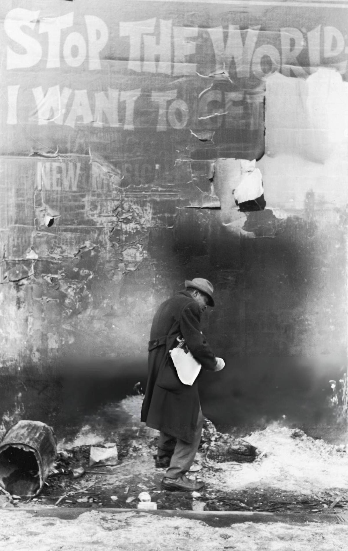 Man Walking On A Snowy Sidewalk Near East Houston And Bowery Streets Past A Theater Poster, New York, 1963.