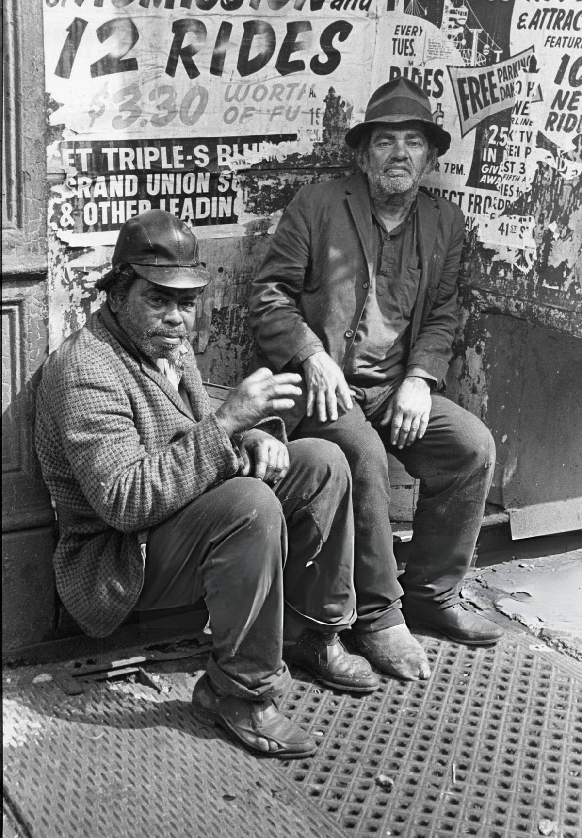 Two Men Sitting On A Sidewalk In The Bowery, New York, 1966.