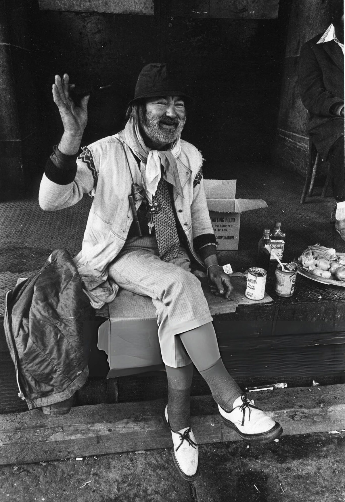 Man Sitting On A Loading Dock With Food And Liquor In The Bowery, New York, 1972.
