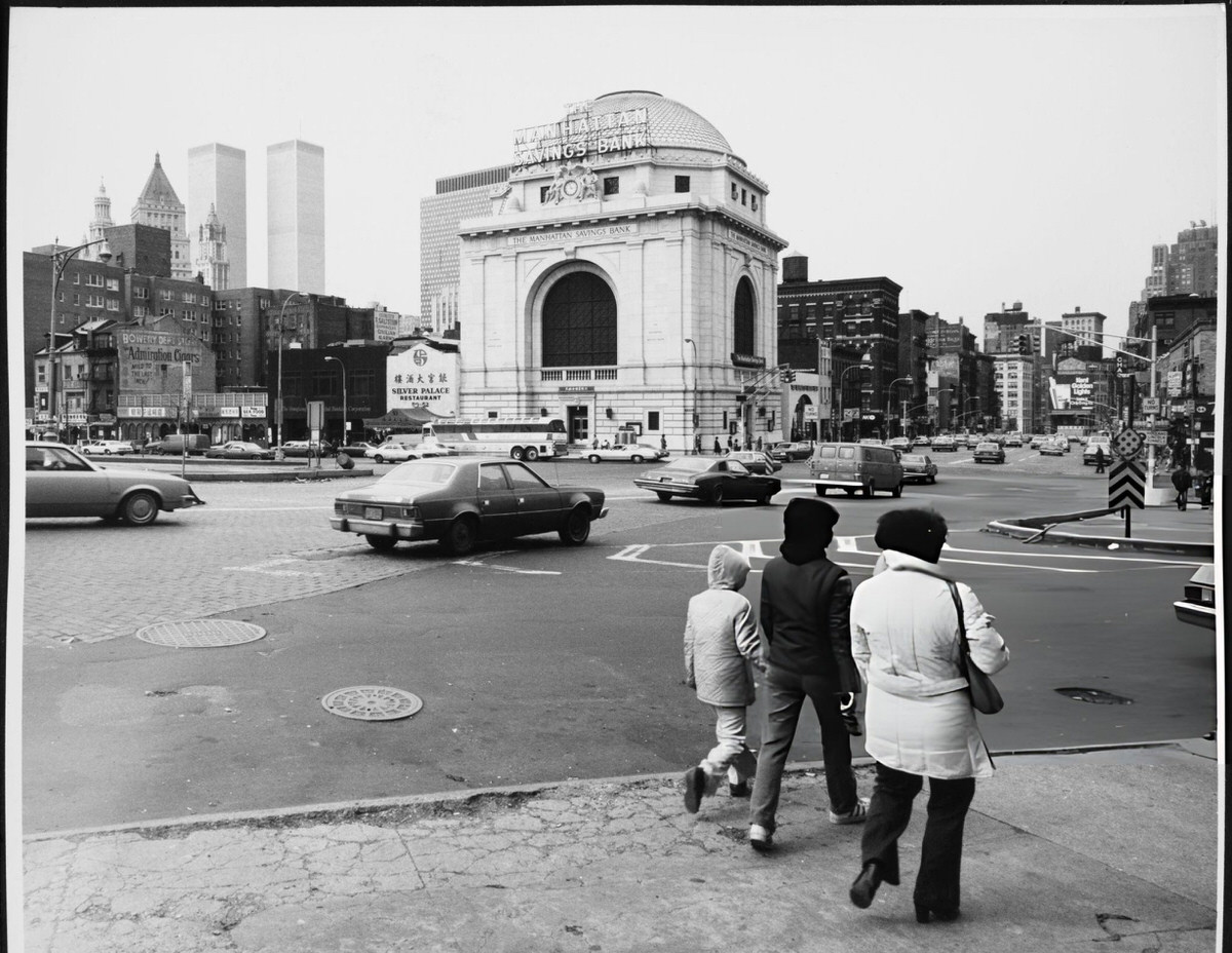 Traffic At Bowery And Canal Street With The Manhattan Savings Bank And World Trade Center In The Background, New York, 1977.