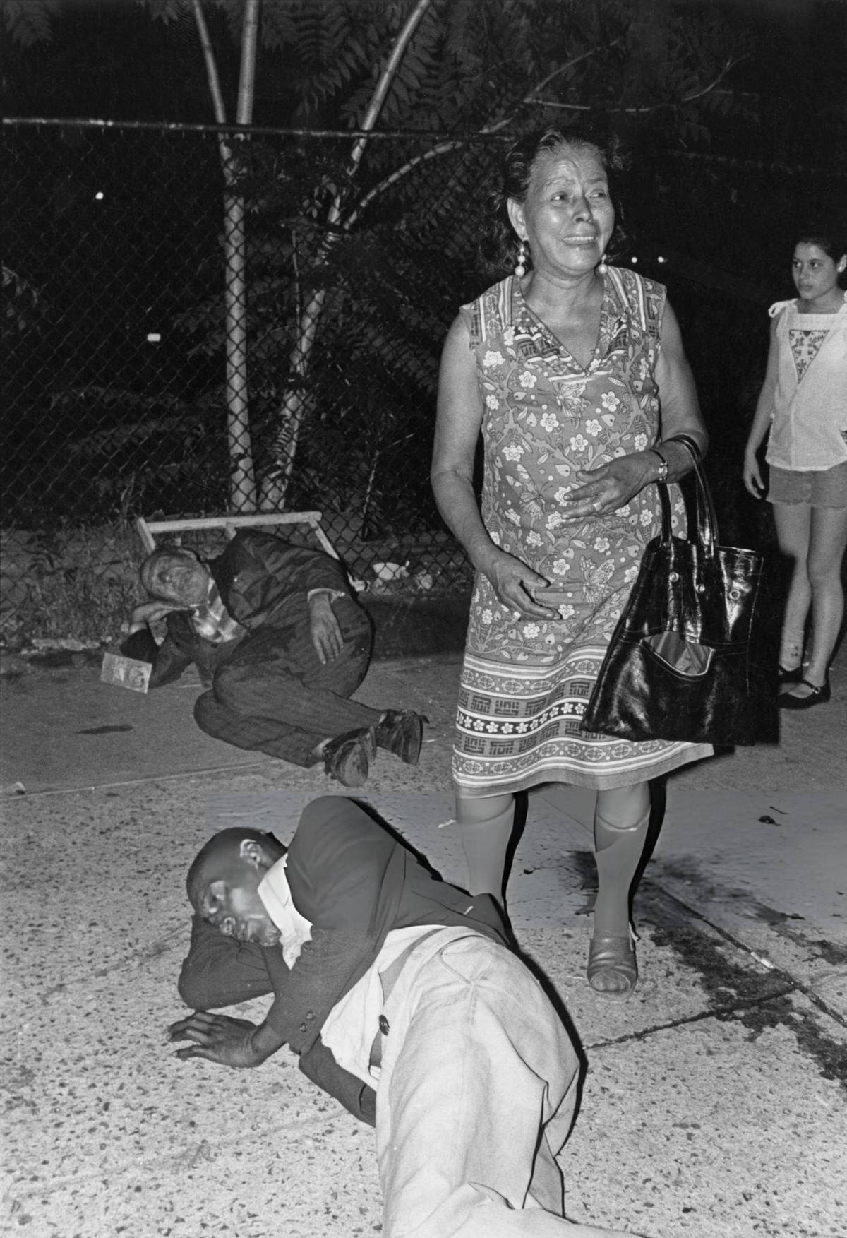 Two Men Lying On The Pavement Near The Bowery, New York, 1978.