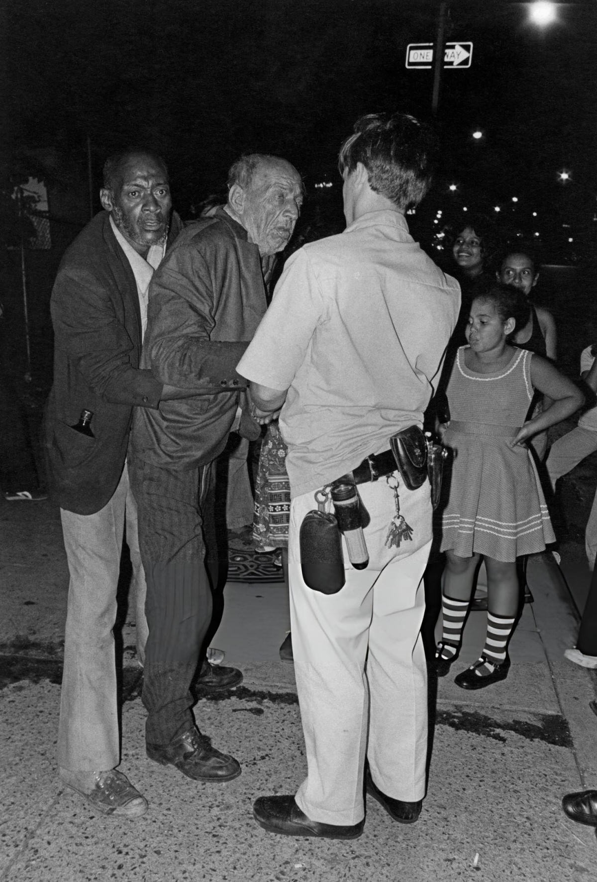 Man Helping Another Man To His Feet On The Bowery, New York, 1978.