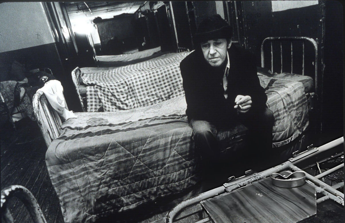 Man Sitting On His Bed In A Dormitory At A Bowery Flophouse, New York, 1990S.