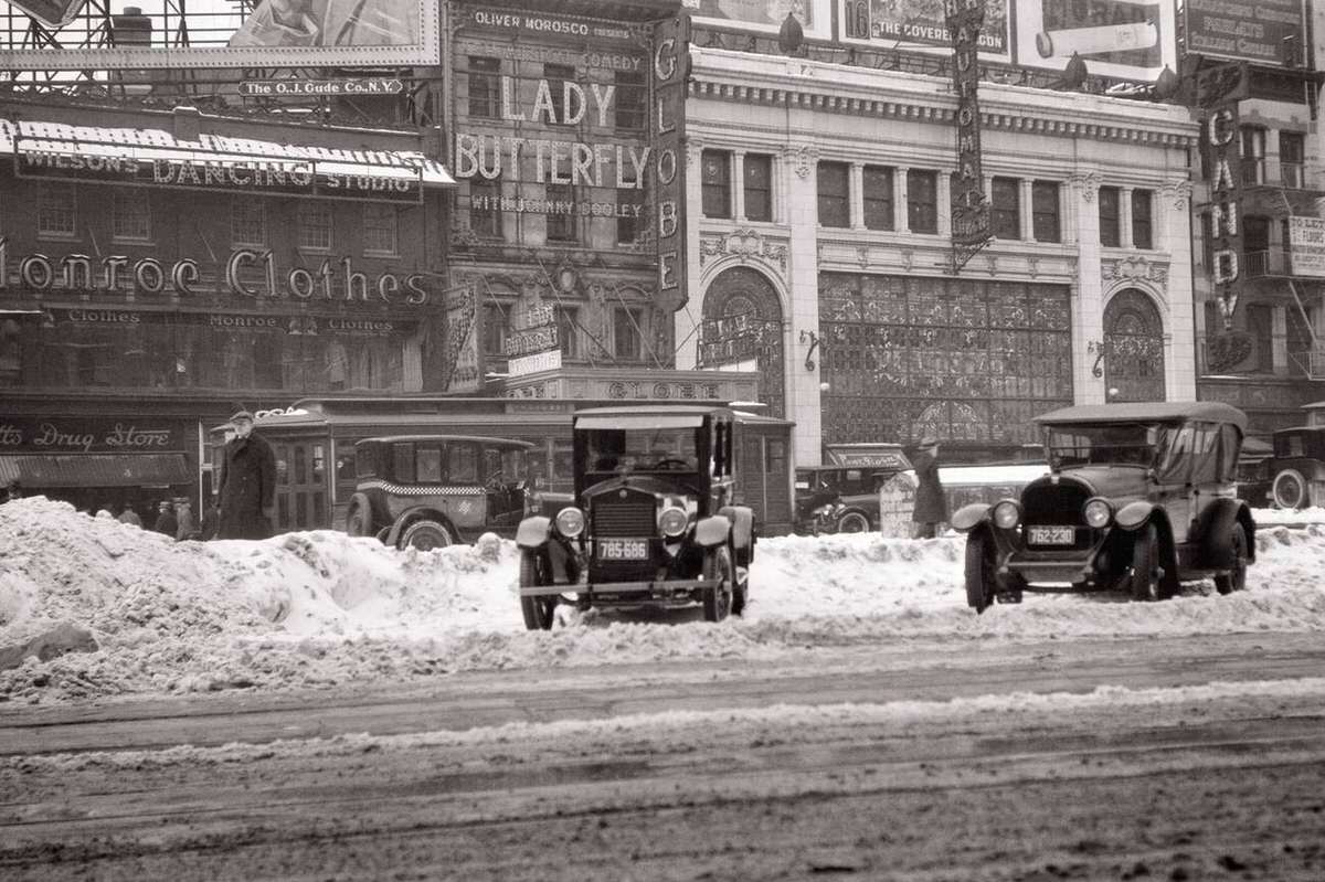 Winter Scene In Times Square With Cars In Snow Near The Horn And Hardart Automat And Globe Theater, New York, 1923.