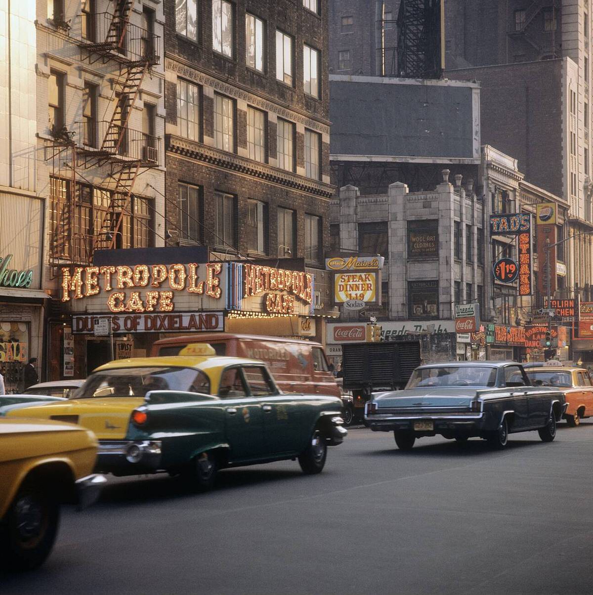 Taxis And Cars On Broadway Near Times Square With The Metropole Cafe In Focus, Manhattan, 1964.