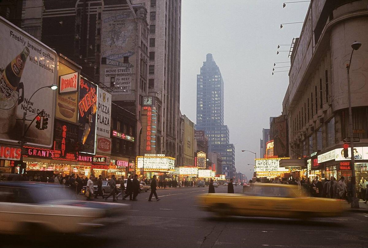 Broadway In The Evening With Cars, Pedestrians, And Illuminated Signs, New York, 1967.