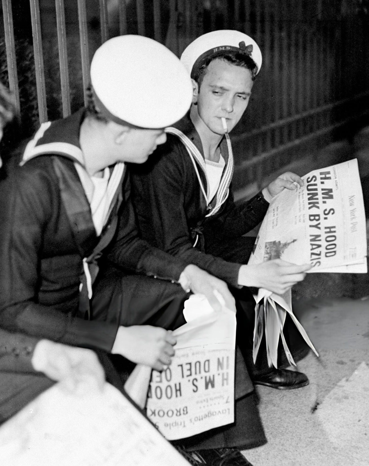 British Sailors From The Hms Malaya Reading About The Sinking Of The Hms Hood In Front Of The Brooklyn Navy Yard, 1941.