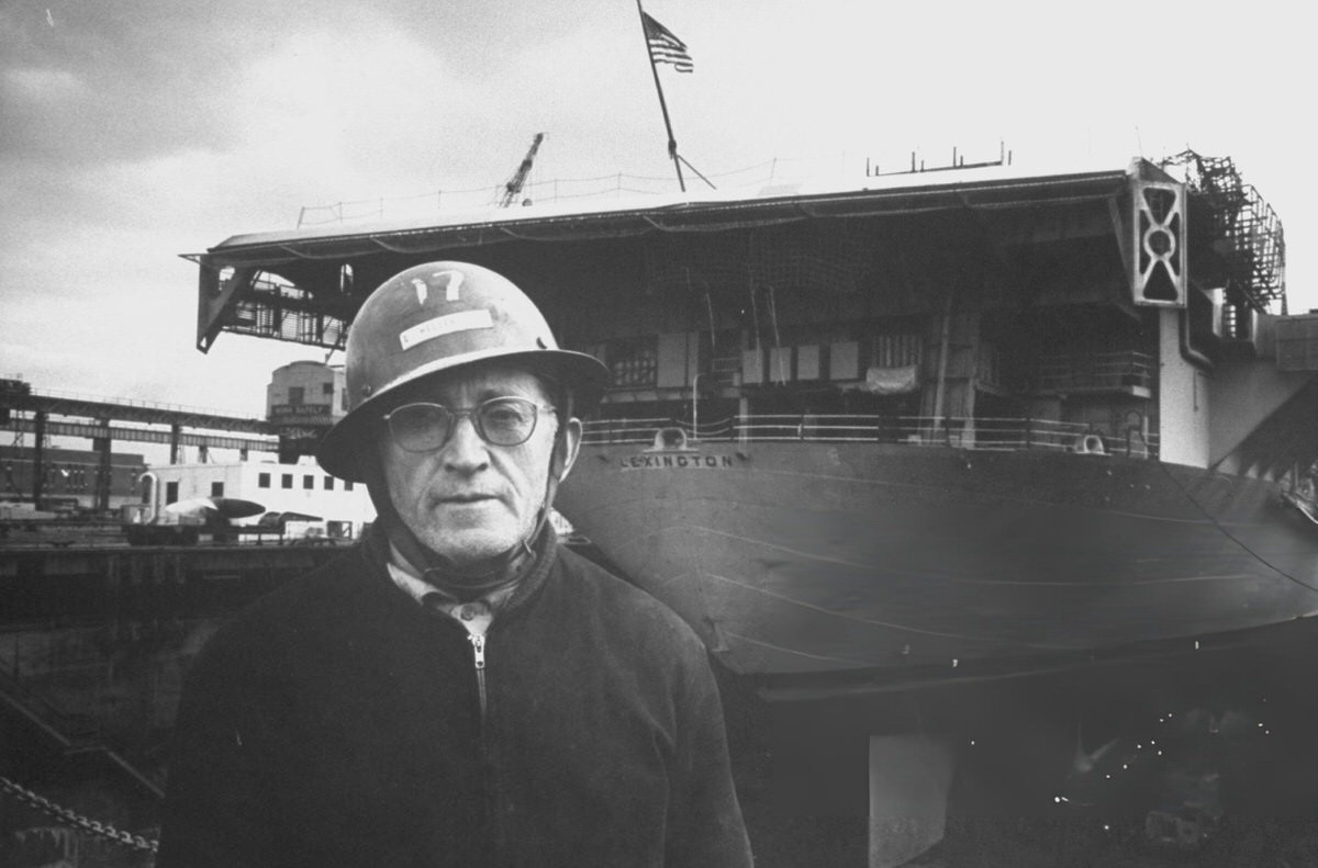 Worker Standing Near The Uss Lexington At The Brooklyn Navy Yard, 1964.