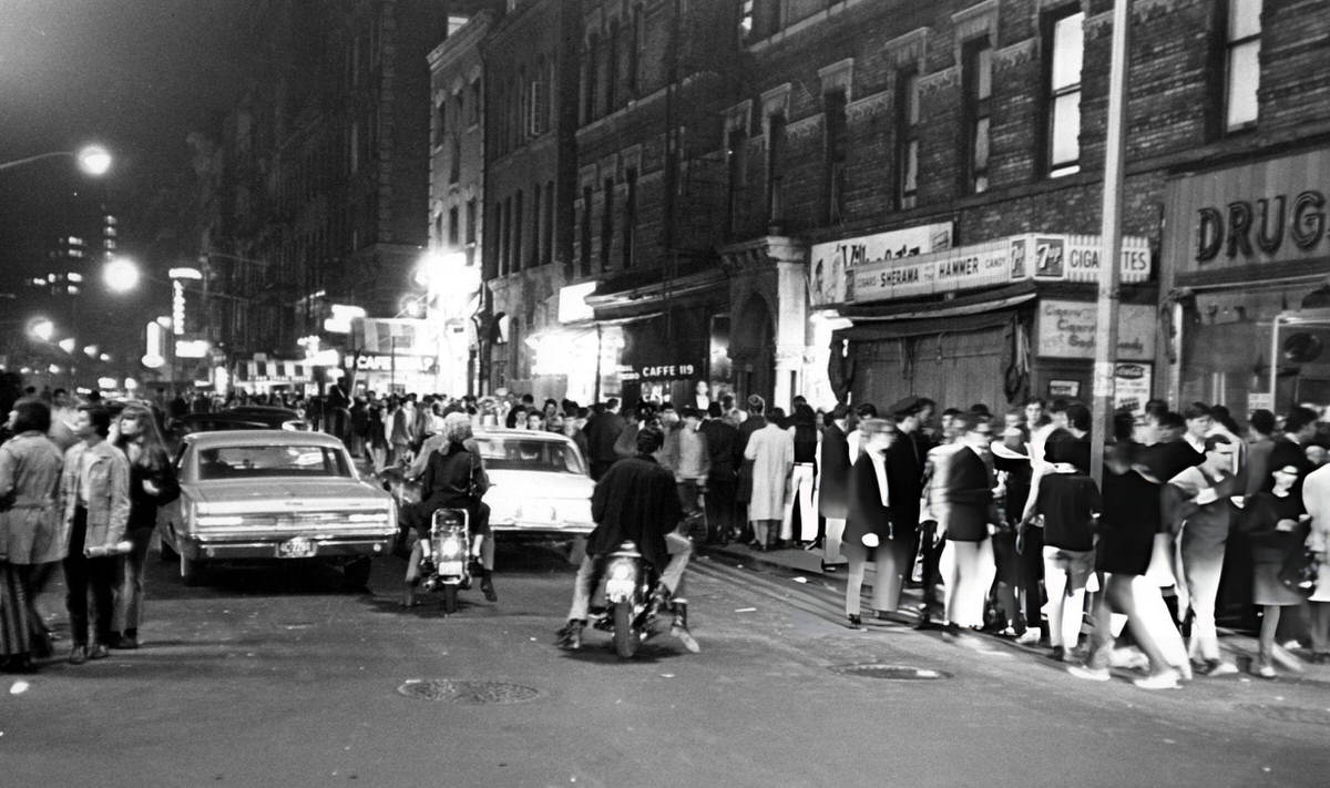 Pedestrians And Cars On Macdougal Street At West 3Rd Street At Night With The Cafe Wha? Awning Visible, Greenwich Village, 1966.