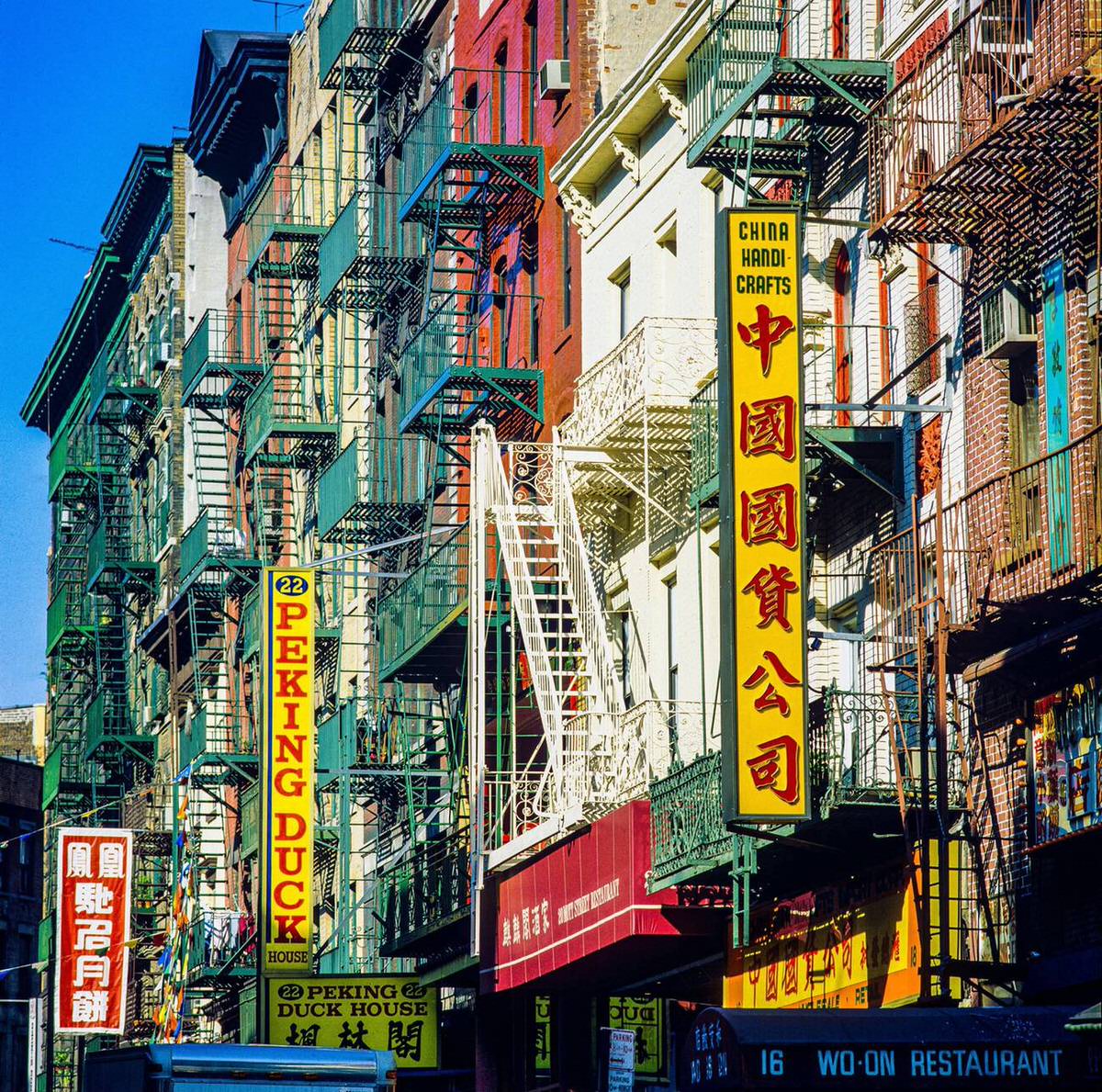 Buildings With Chinese Business Signs And Fire Escapes On Mott Street, Chinatown, 1985.