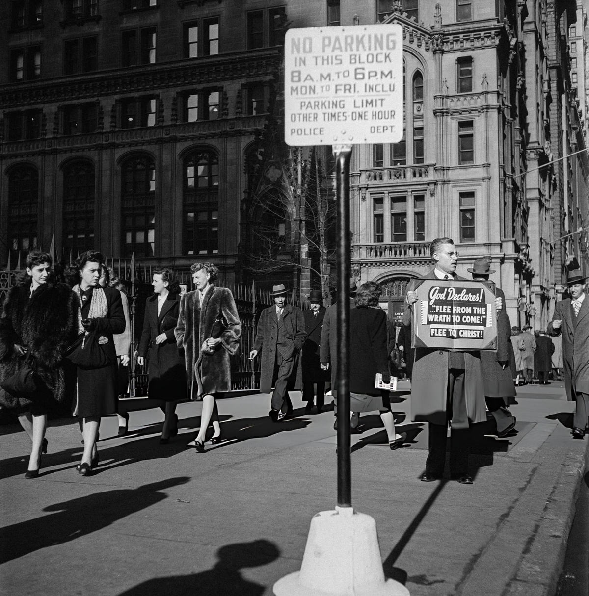 Pedestrians Passing A Man Preaching At The Gates Of Trinity Church, 1947.