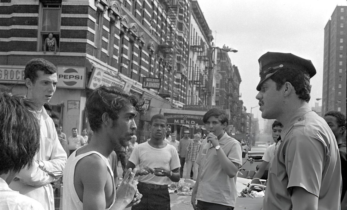 Police Officer Talking With Community Members During The Young Lords Party'S Garbage Offensive In El Barrio, East Harlem, 1969.