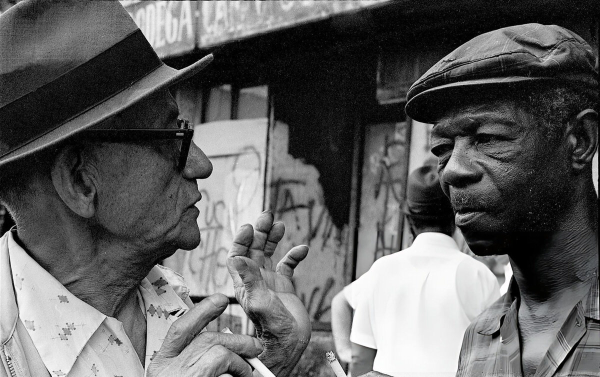 Two Elderly Men Talking On A Sidewalk During The Young Lords Party'S Garbage Offensive In El Barrio, East Harlem, 1969.