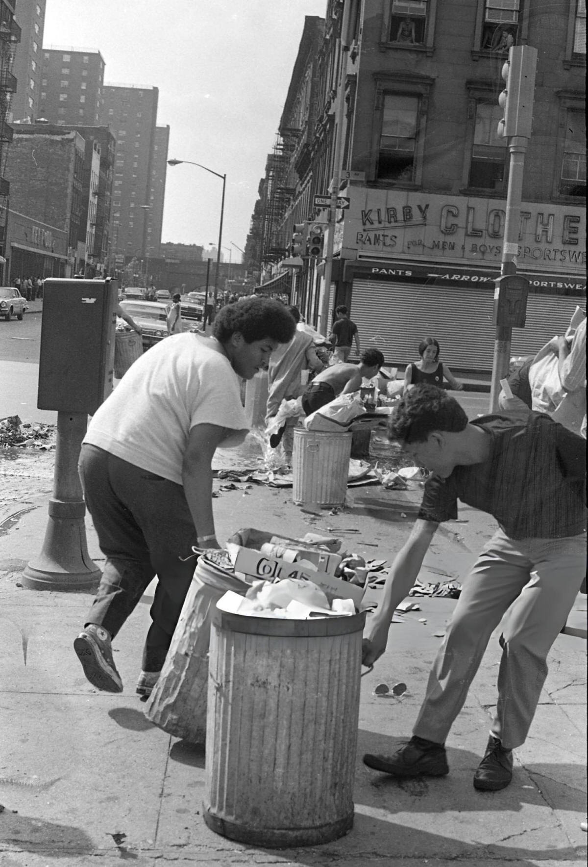 Young Men Dragging Garbage Cans Into The Intersection Of East 110Th Street And 3Rd Avenue During The Young Lords Party'S Garbage Offensive, East Harlem, 1969.