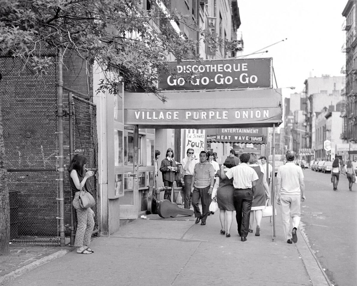 Young Adults Walking Past The Purple Onion Go-Go Bar, Greenwich Village, 1966.