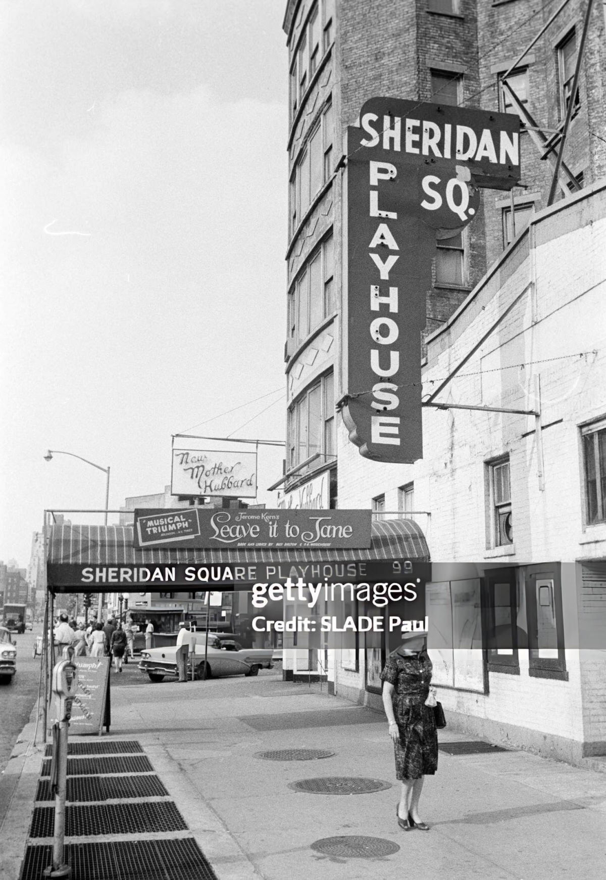 Pedestrian In Front Of The Sheridan Square Playhouse, Greenwich Village, 1961.