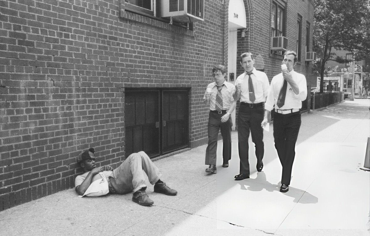 Men Walking Past A Homeless Man In Greenwich Village, 1975.