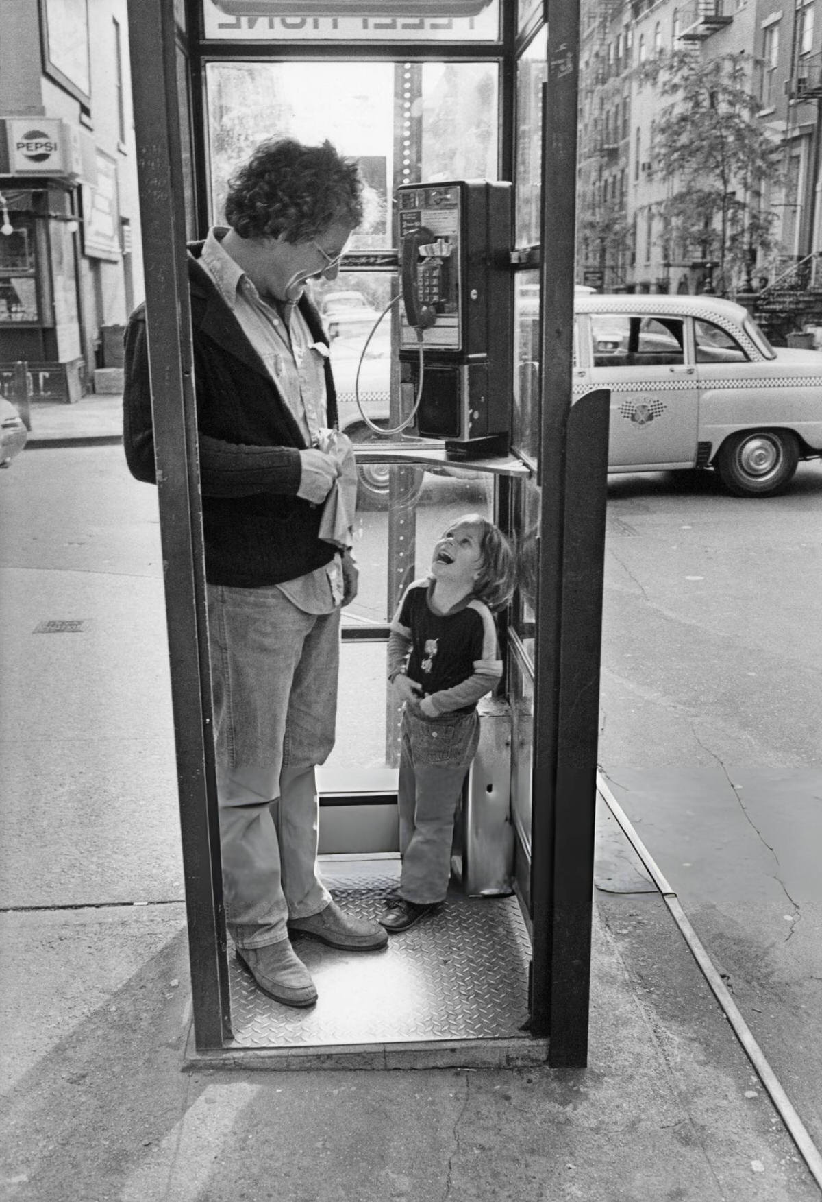 Father And Son In A Phone Booth, Greenwich Village, 1976.