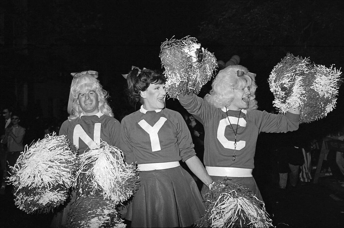 Three Cheerleaders With Pom-Poms At The Village Halloween Parade, New York, 1982.