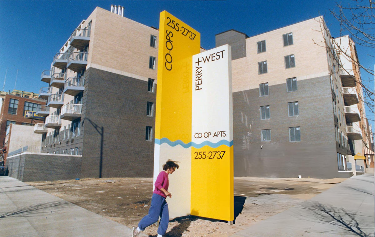Pedestrian Passing New Co-Op Buildings At Perry And West Streets, Greenwich Village, 1987.