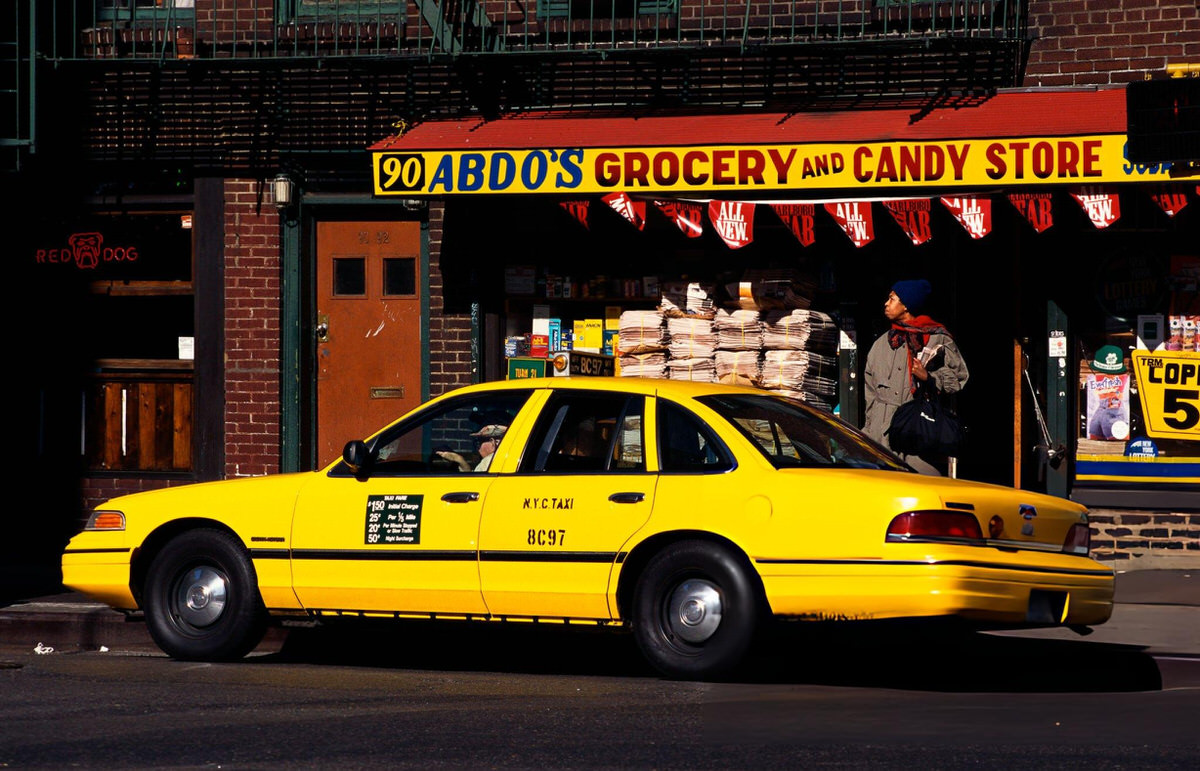 Yellow Taxi Parked Outside A Grocery Store In Greenwich Village.