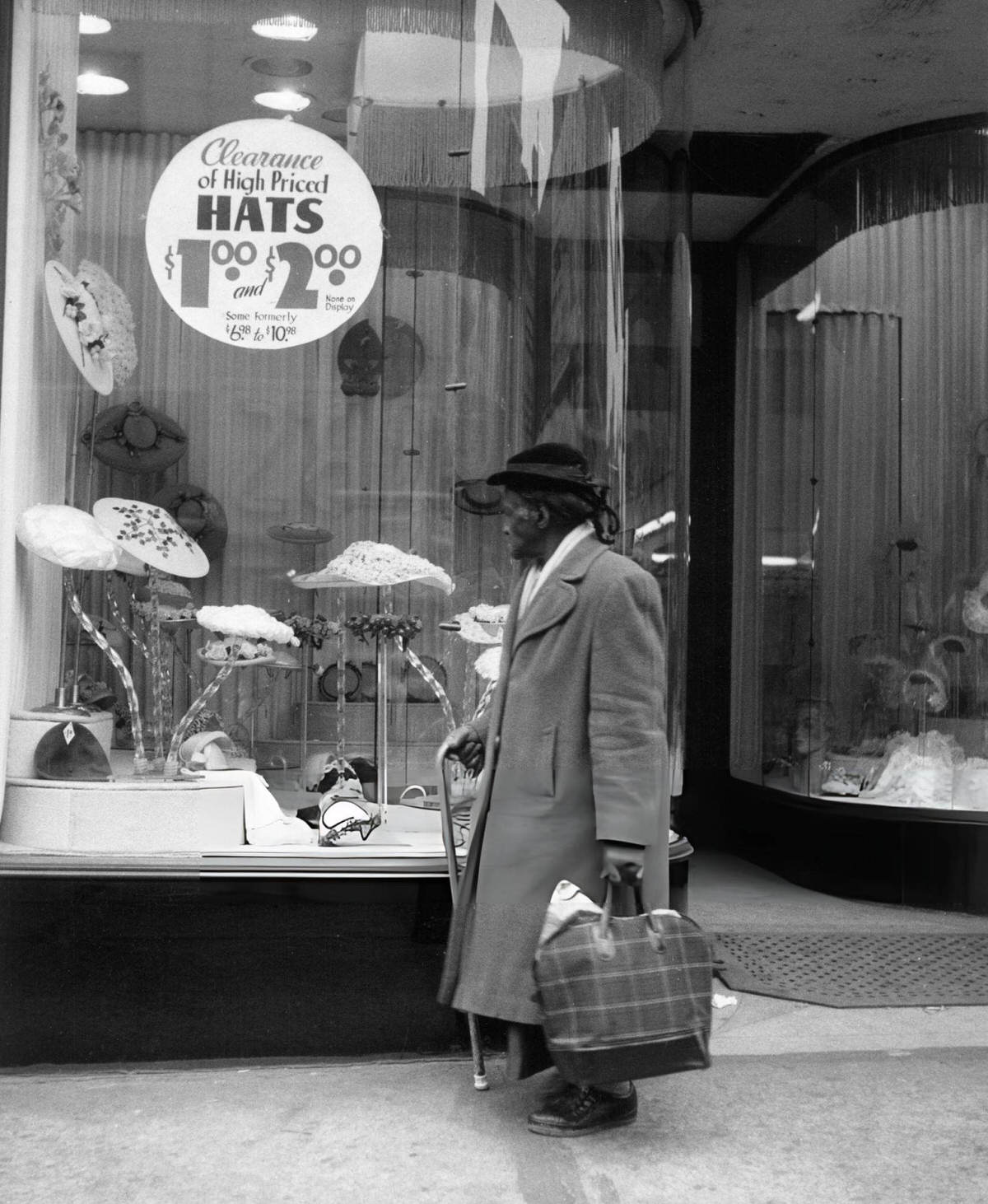 Elderly Man Looking In The Window Of A Hat Shop, Harlem, 1956.