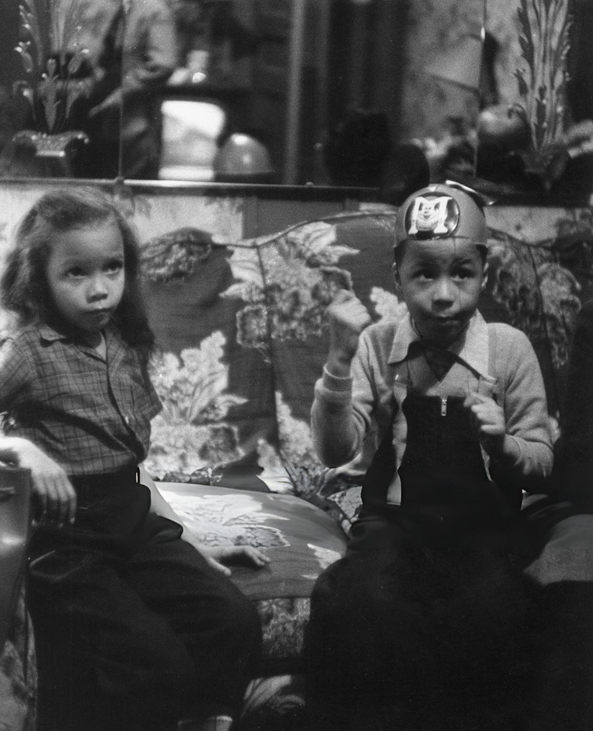 Two Children Sitting On A Divan In A Harlem Home, 1956.