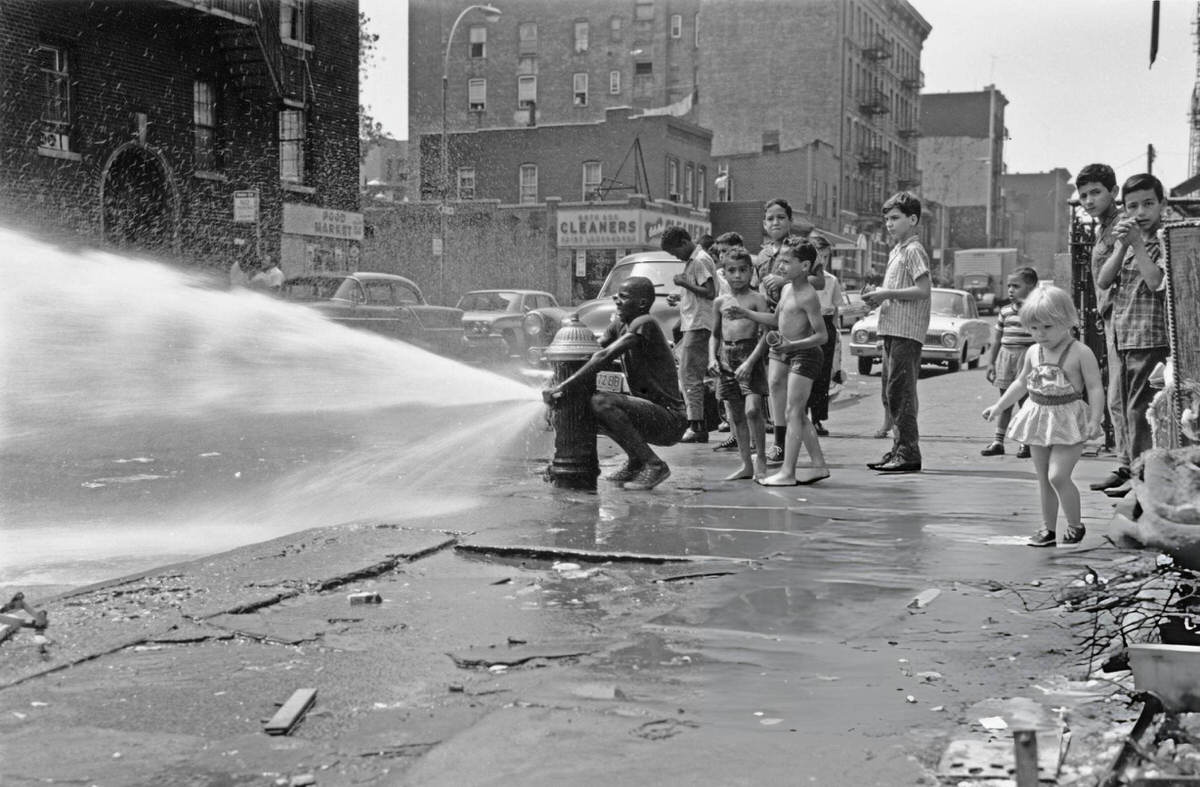 Boy Opening A Fire Hydrant On A Hot Day, Harlem, 1955.