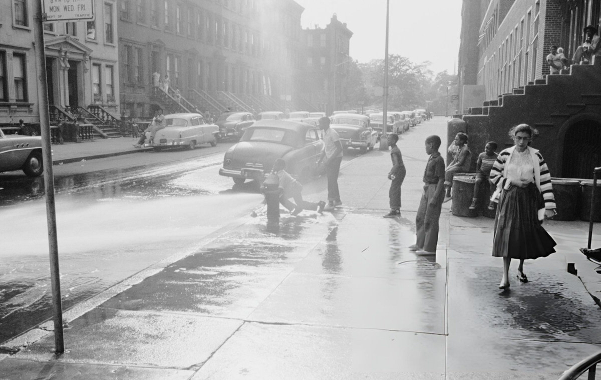Children Playing In The Spray From A Fire Hydrant, Harlem, 1957.