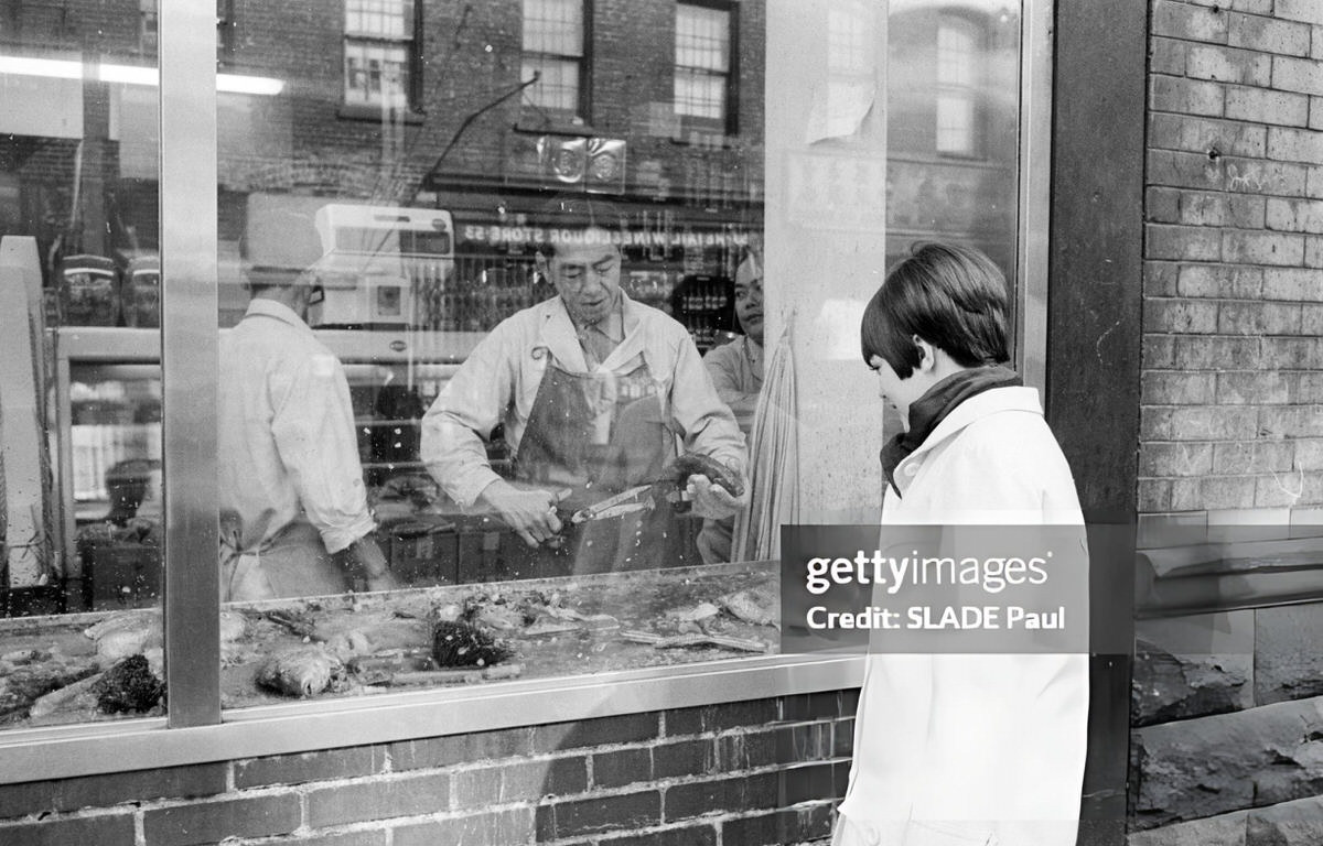 Mireille Mathieu Observing Employees At A Fish Market In Harlem, 1966.