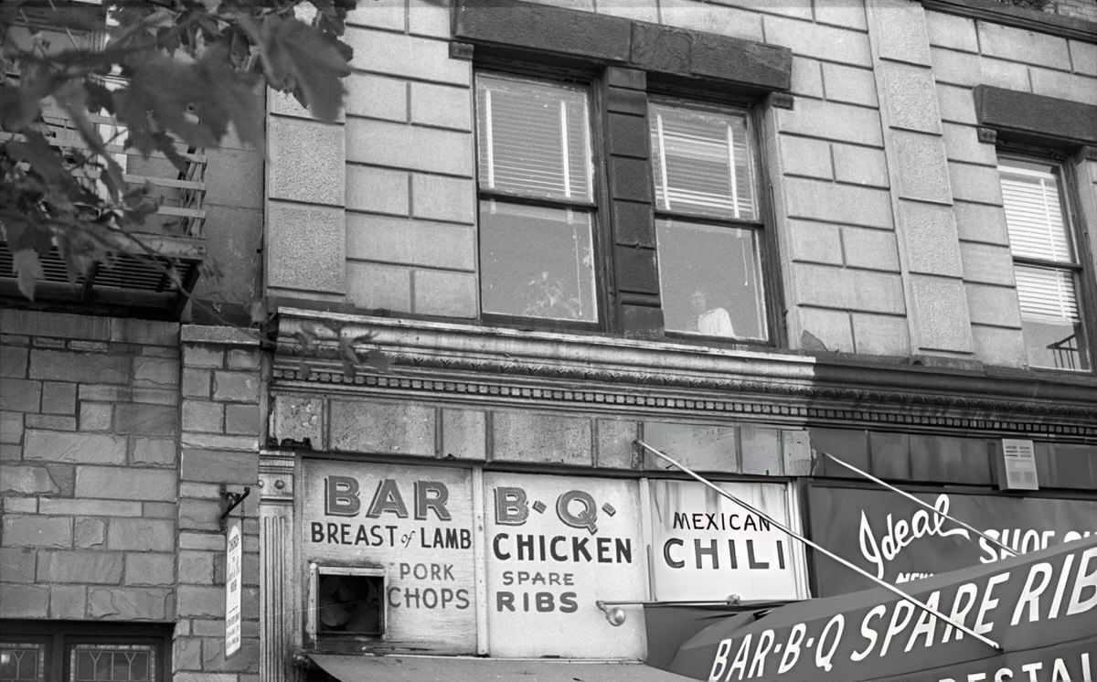 Woman Looking Out A Window Above Belton'S Bar B-Q Restaurant At 125Th Street And Lexington Avenue, Harlem, 1968.