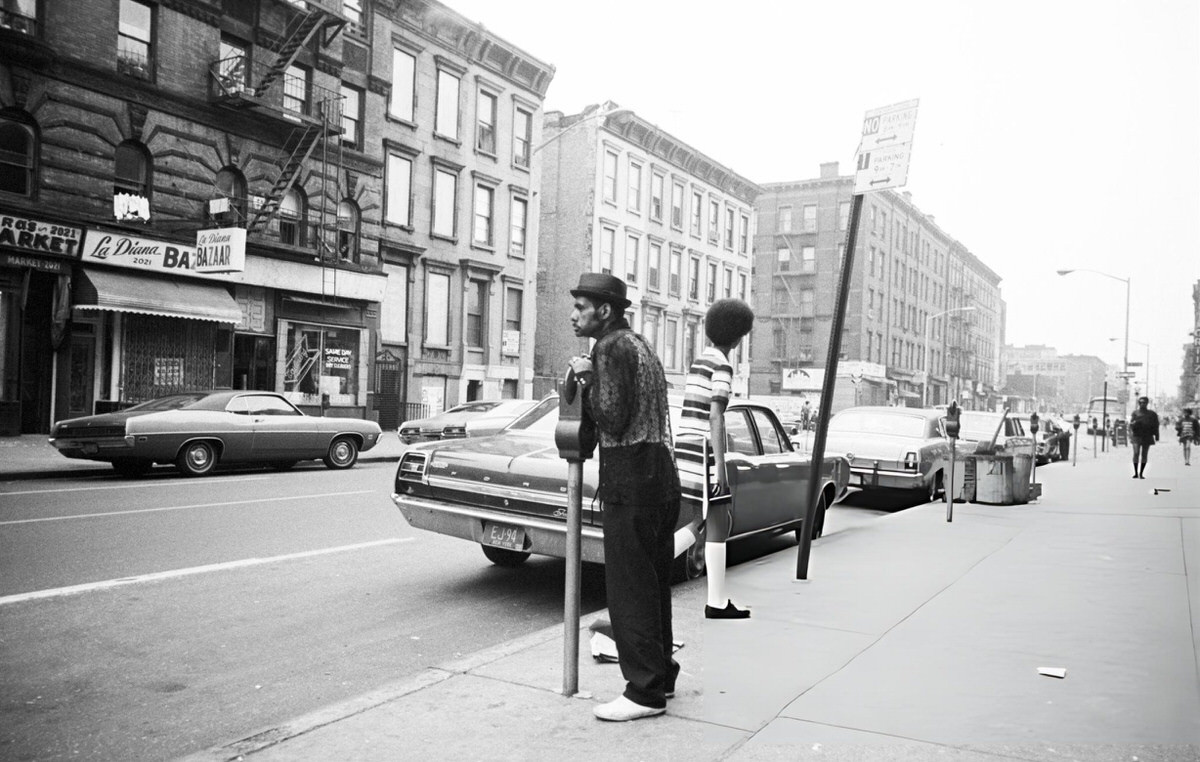 Man Leaning On A Parking Meter On A Harlem Street, 1970.