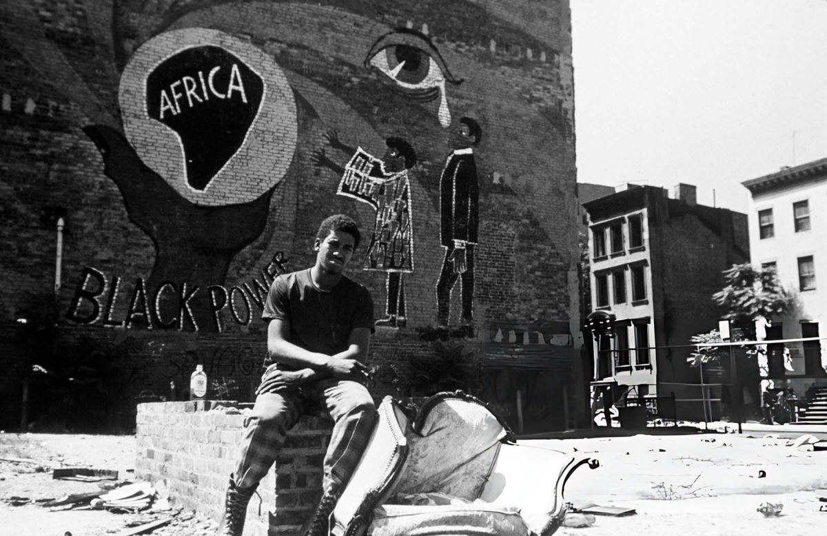 Man Sitting On A Wall Near Graffiti Reading &Amp;Quot;Africa - Black Power,&Amp;Quot; Harlem, 1970.